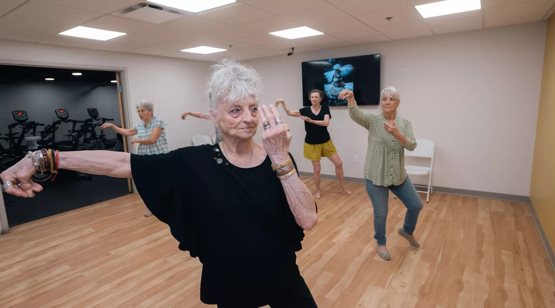 A group of older adults doing tai chi