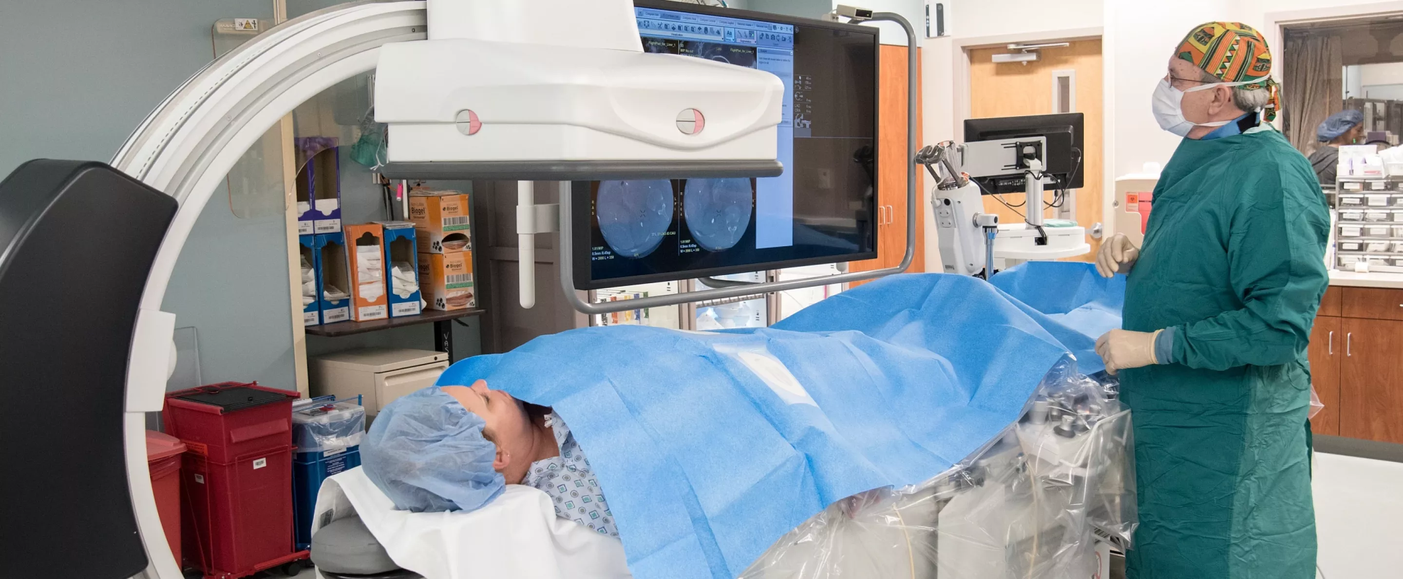 Doctor performs tests on patient in radiology lab