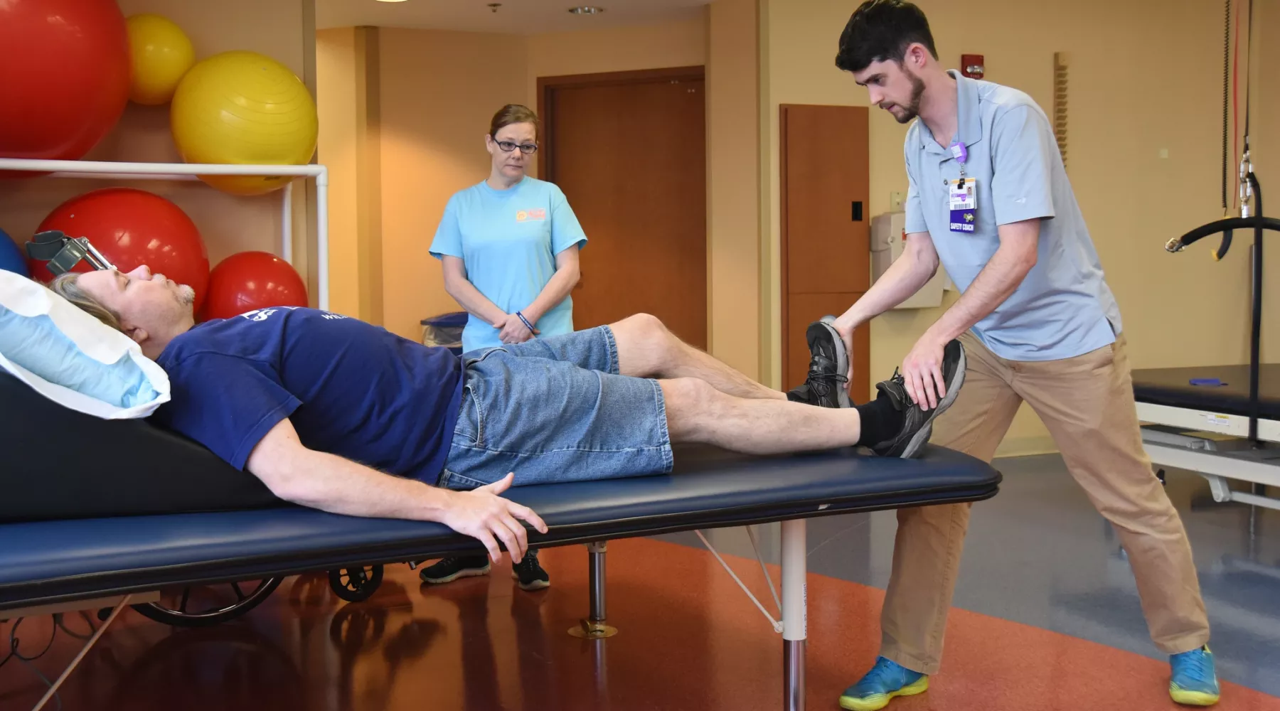 Doctor helps patient with movement in his legs
