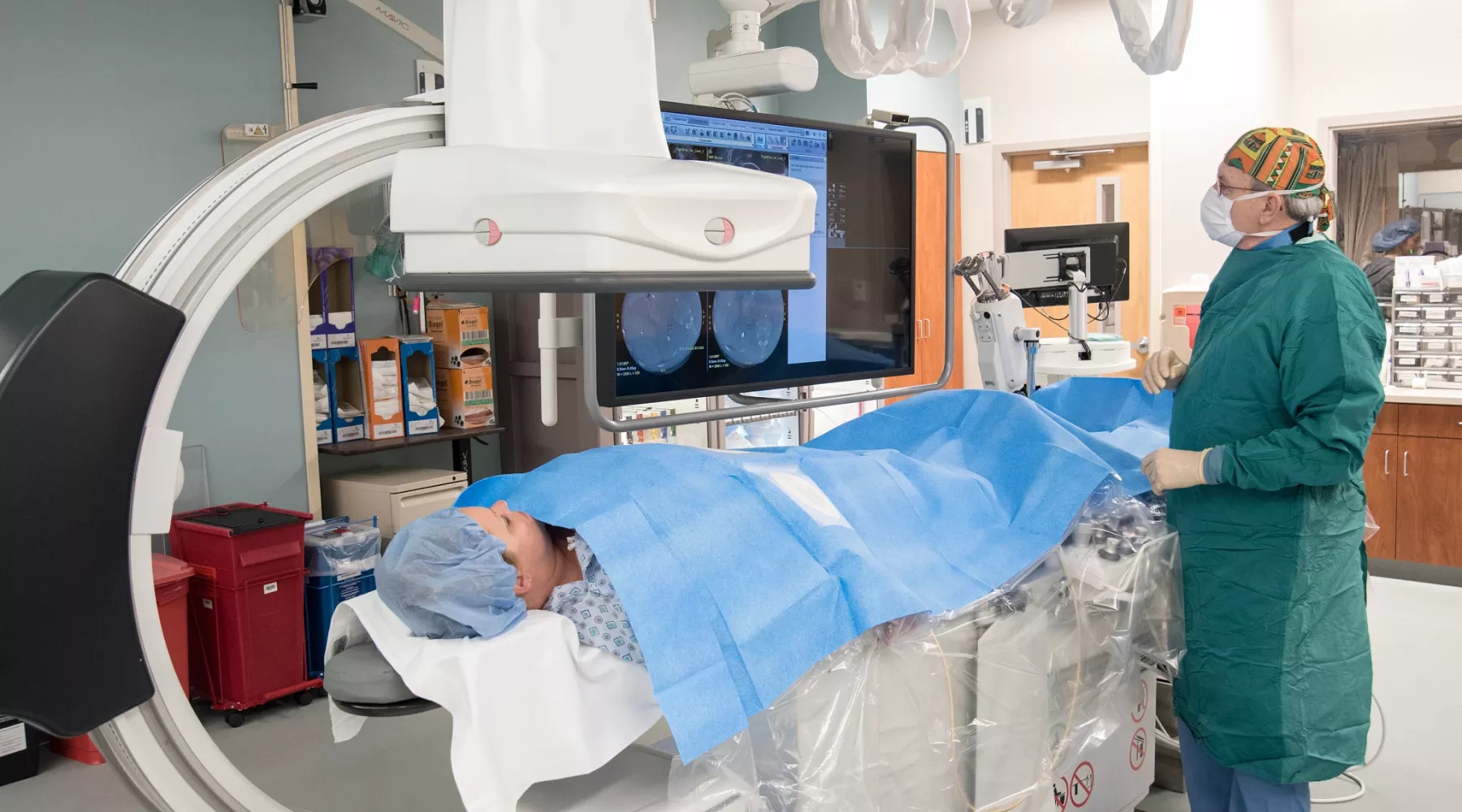 Doctor performs tests on patient in radiology lab