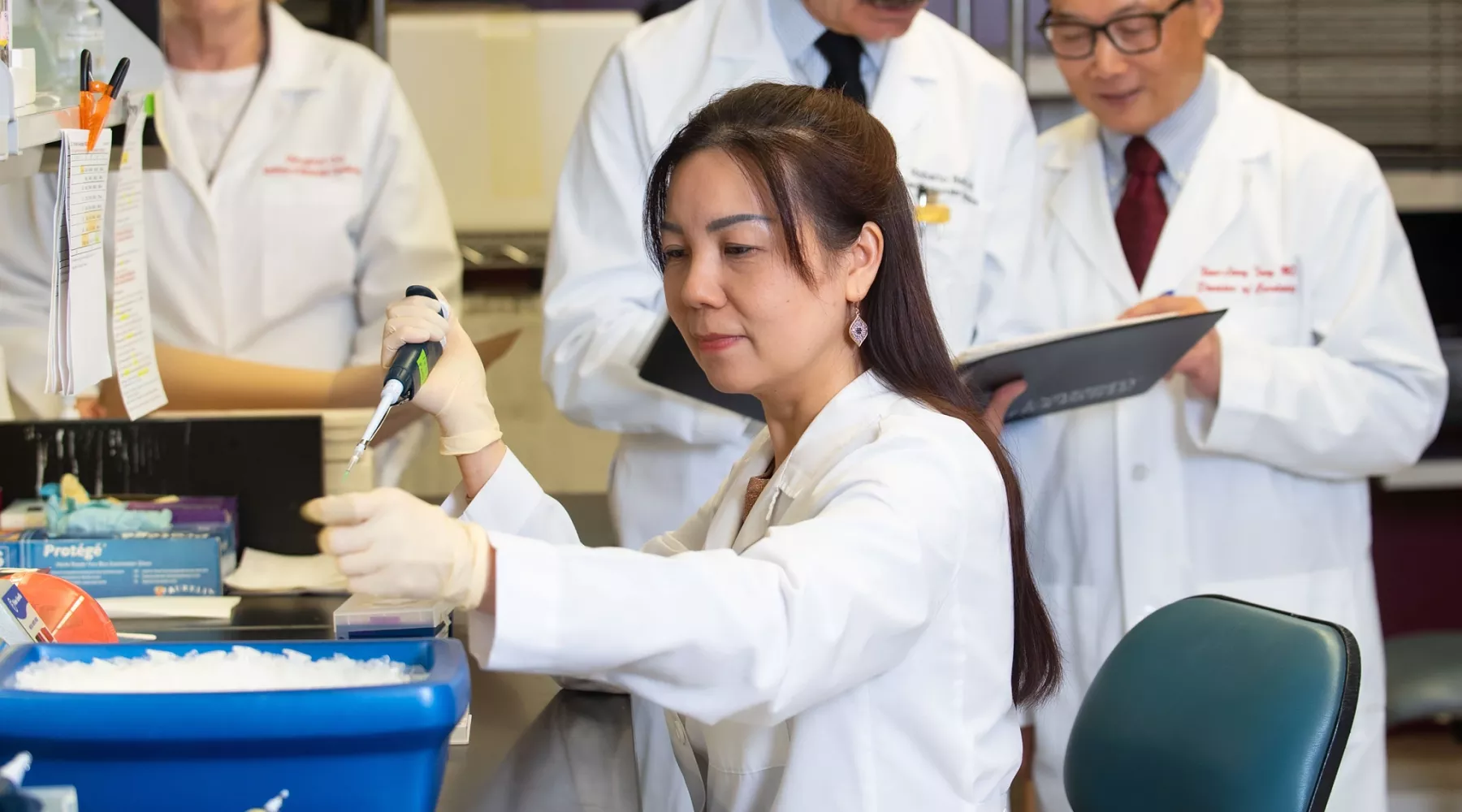 A group of researchers working in a lab setting.