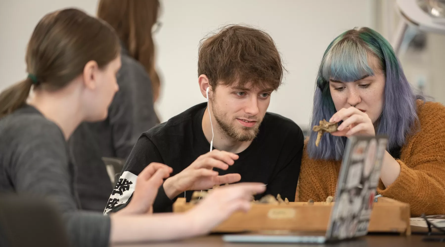 A group of students study a bone in an Anthropology Lab