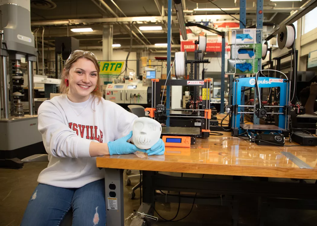 Engineering student Sophie Wegenast posing with a 3D printed face mask at the Additive Manufacturing Institute for Science…
