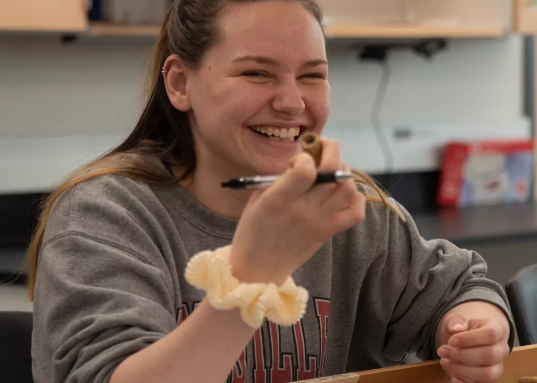 Laughing student learns more about bones in Anthropology Lab