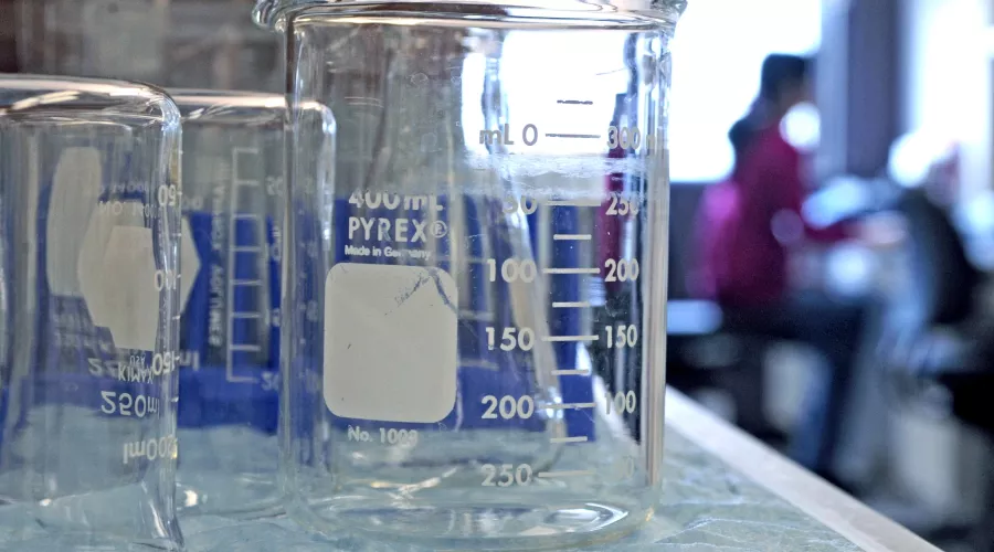 Close up images of beakers in a lab