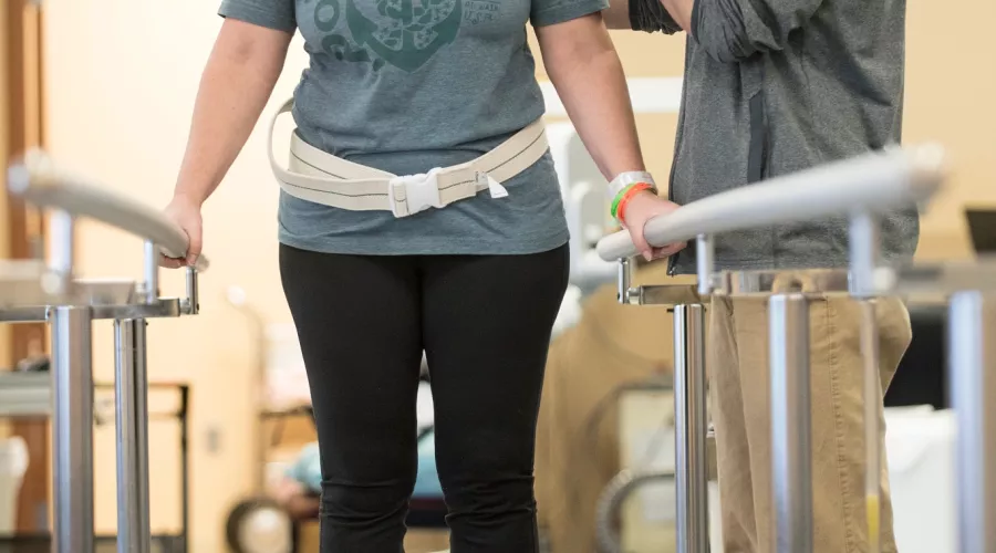 Doctor helps patient with exercises