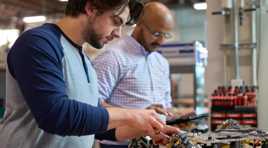 Student and professor work on an engineering project.