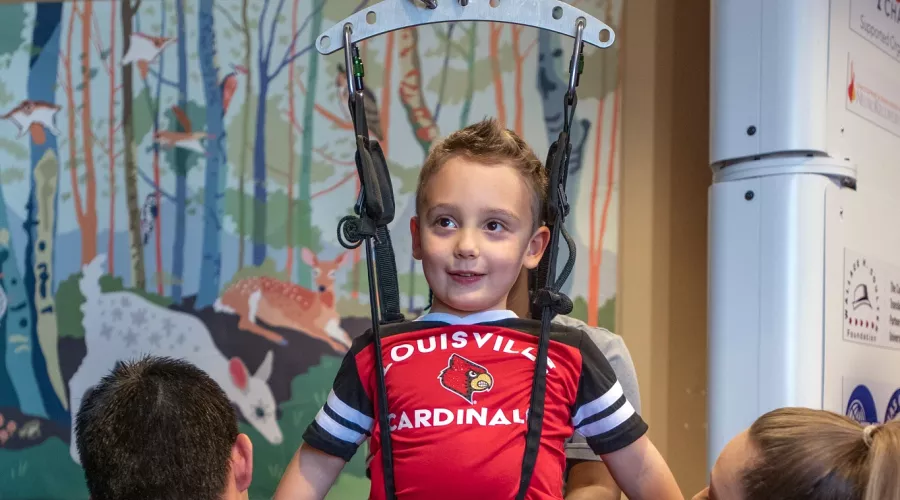 Malcolm MacIntyre on a pediatric treadmill system, designed for use with spinal cord injuries
