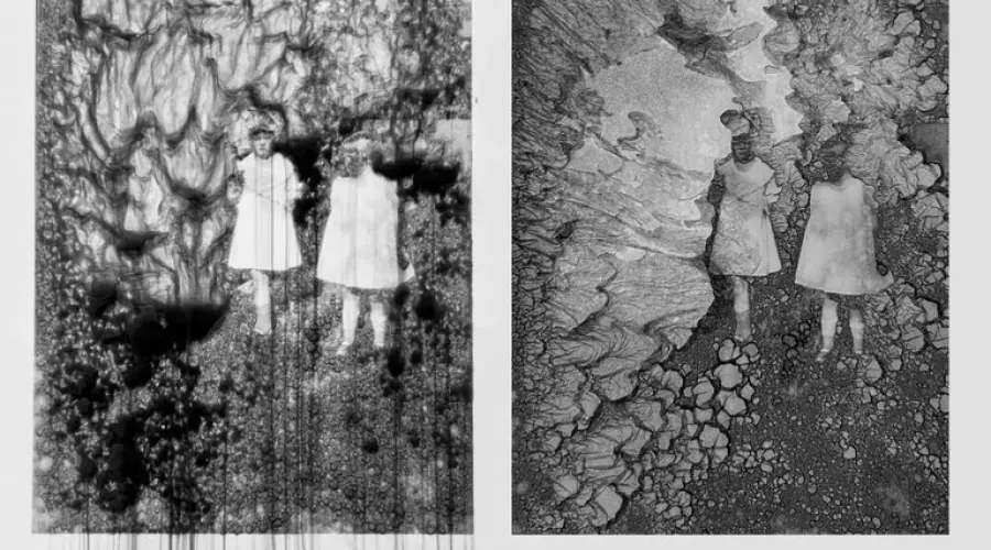 Two vertical panels showing black and white stills of two human figures in shapeless dresses on organic formations.