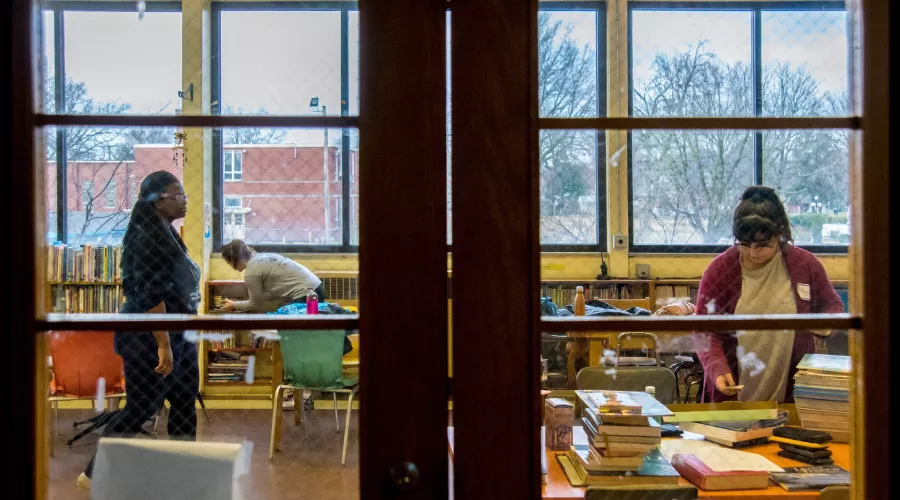 Students in a classroom shot from behind closed doors looking in